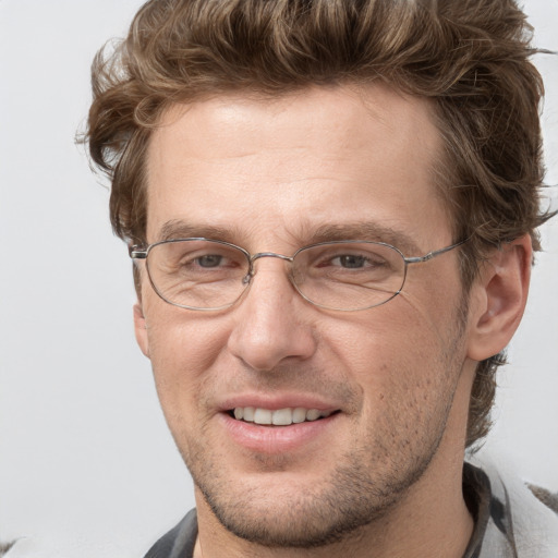 Joyful white adult male with short  brown hair and grey eyes