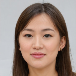 Joyful asian young-adult female with long  brown hair and brown eyes