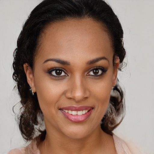 Joyful black young-adult female with medium  brown hair and brown eyes