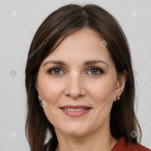 Joyful white adult female with long  brown hair and brown eyes