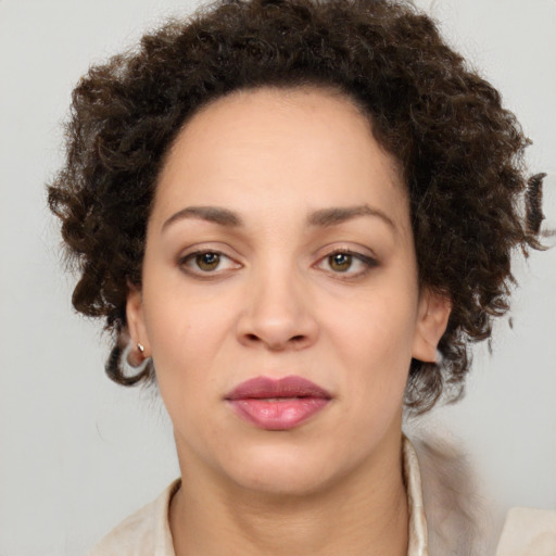 Joyful black young-adult female with medium  brown hair and brown eyes
