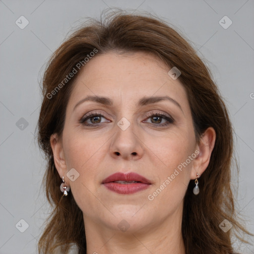 Joyful white adult female with long  brown hair and brown eyes