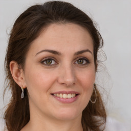 Joyful white young-adult female with long  brown hair and green eyes