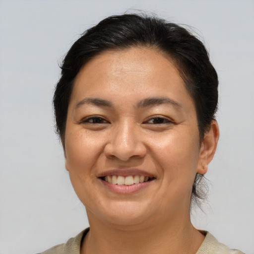 Joyful asian adult female with medium  brown hair and brown eyes