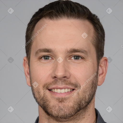 Joyful white young-adult male with short  brown hair and grey eyes