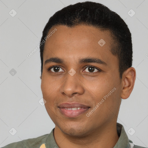 Joyful black young-adult male with short  black hair and brown eyes