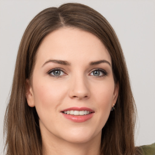 Joyful white young-adult female with long  brown hair and grey eyes