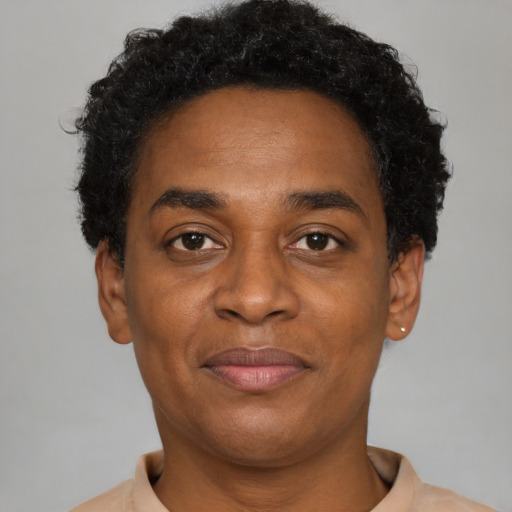 Joyful black adult male with short  brown hair and brown eyes
