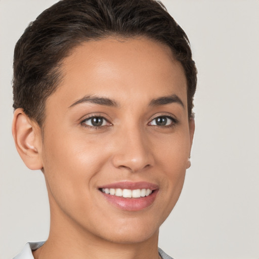 Joyful white young-adult female with short  brown hair and brown eyes