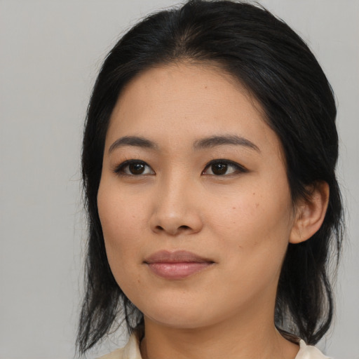 Joyful asian young-adult female with medium  black hair and brown eyes
