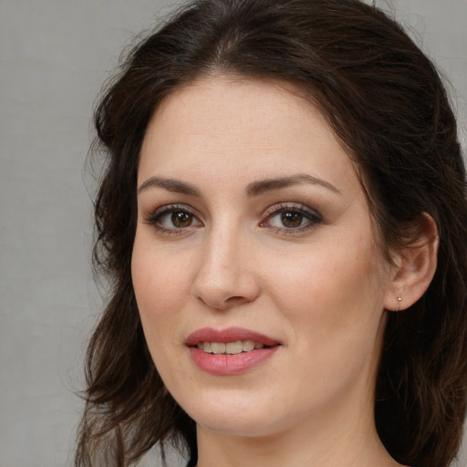 Joyful white young-adult female with long  brown hair and brown eyes