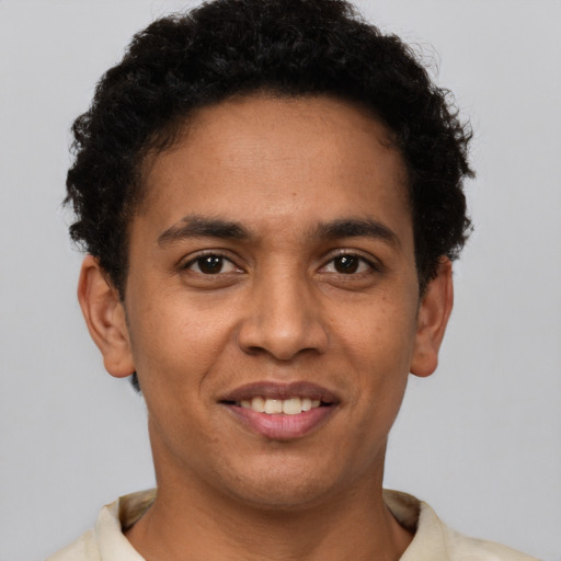 Joyful latino adult male with short  brown hair and brown eyes