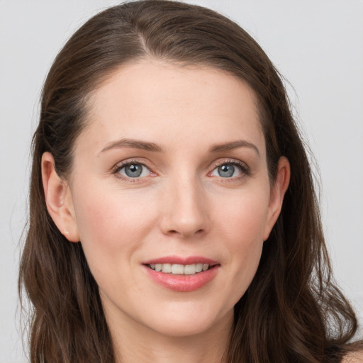 Joyful white young-adult female with long  brown hair and grey eyes