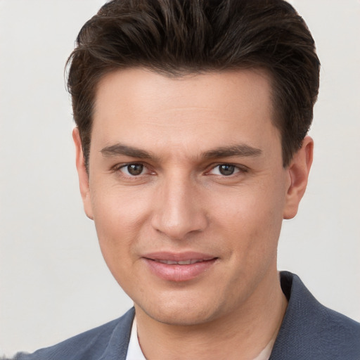 Joyful white young-adult male with short  brown hair and brown eyes