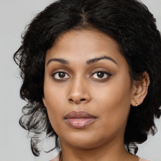 Joyful latino young-adult female with medium  black hair and brown eyes
