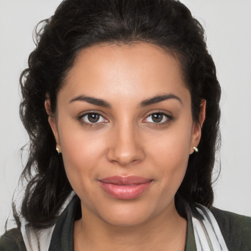 Joyful latino young-adult female with medium  brown hair and brown eyes