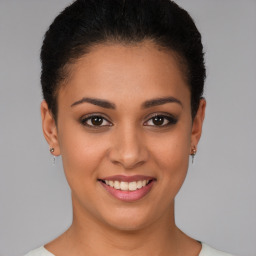 Joyful latino young-adult female with short  brown hair and brown eyes