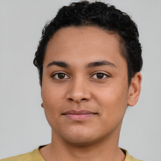 Joyful latino young-adult male with short  brown hair and brown eyes