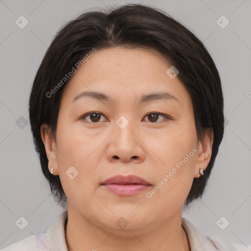 Joyful asian adult female with medium  brown hair and brown eyes