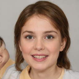 Joyful white young-adult female with medium  brown hair and blue eyes