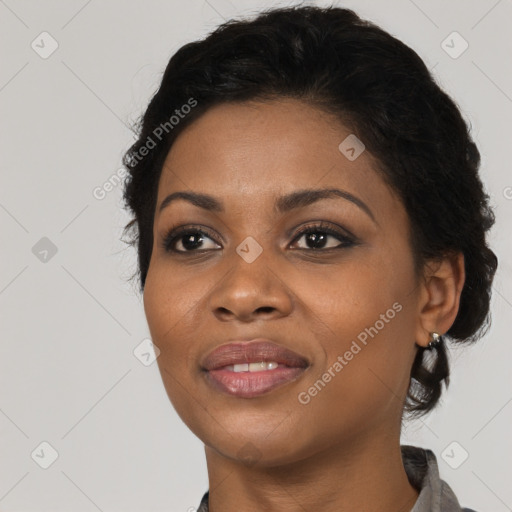 Joyful black young-adult female with short  black hair and brown eyes