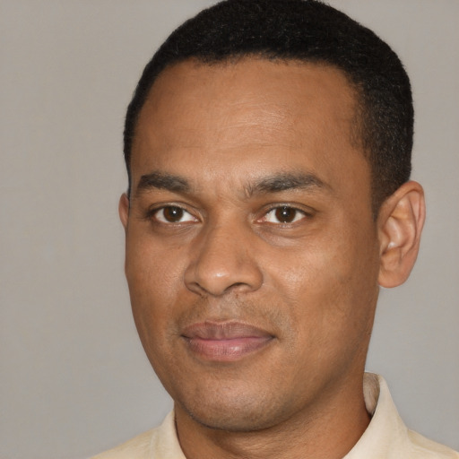 Joyful black young-adult male with short  black hair and brown eyes