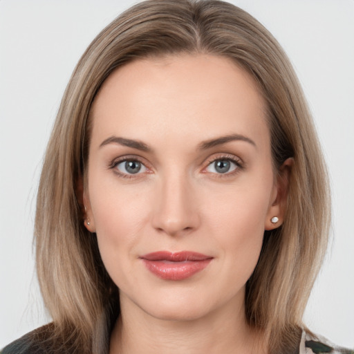 Joyful white young-adult female with long  brown hair and grey eyes