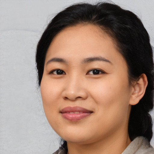 Joyful asian young-adult female with medium  black hair and brown eyes