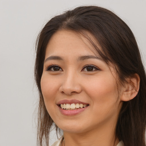 Joyful asian young-adult female with long  brown hair and brown eyes