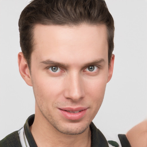 Joyful white young-adult male with short  brown hair and grey eyes