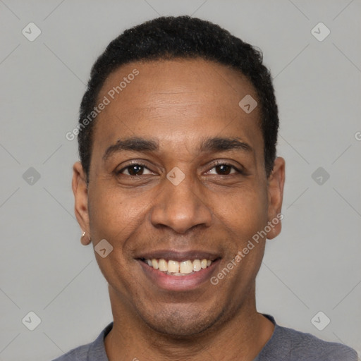 Joyful black adult male with short  black hair and brown eyes