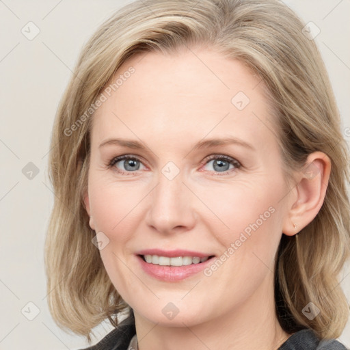 Joyful white adult female with medium  brown hair and blue eyes