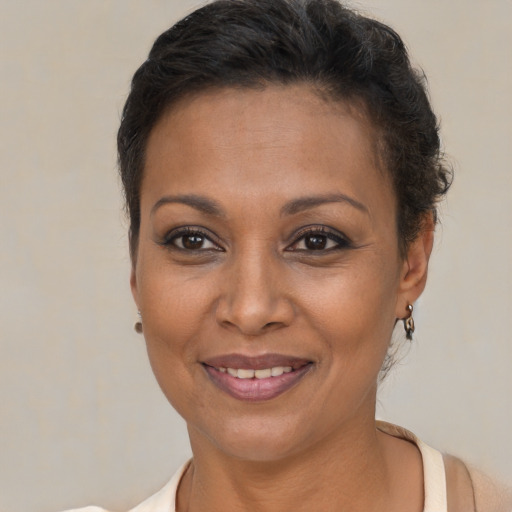 Joyful black young-adult female with short  brown hair and brown eyes