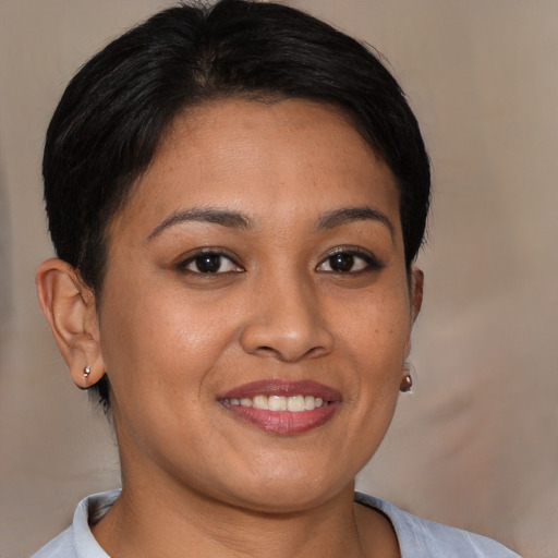 Joyful latino young-adult female with short  brown hair and brown eyes
