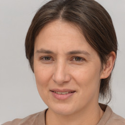 Joyful white adult female with medium  brown hair and brown eyes