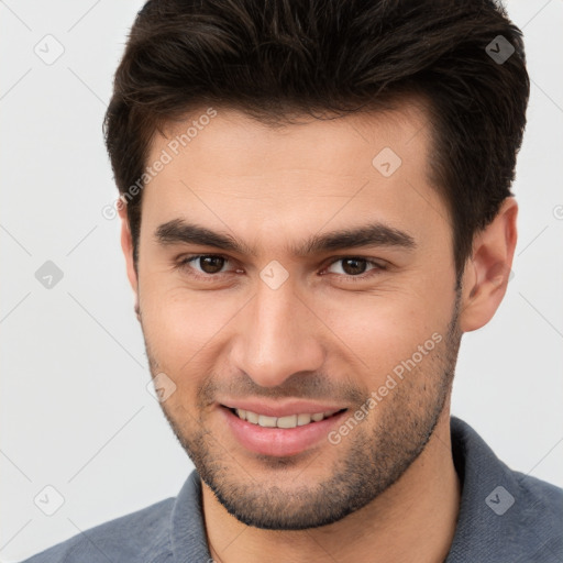 Joyful white young-adult male with short  brown hair and brown eyes