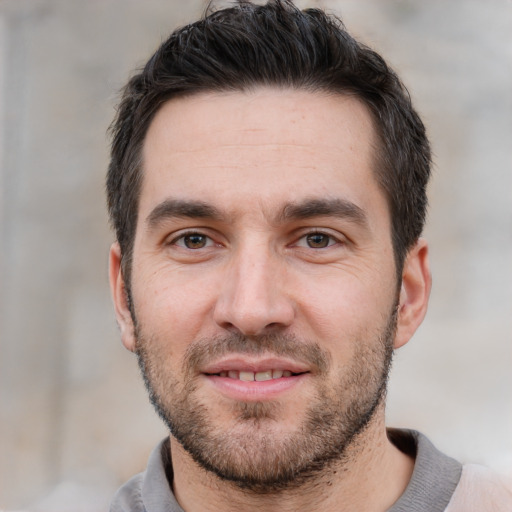 Joyful white young-adult male with short  black hair and brown eyes