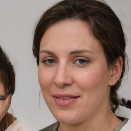 Joyful white adult female with medium  brown hair and brown eyes