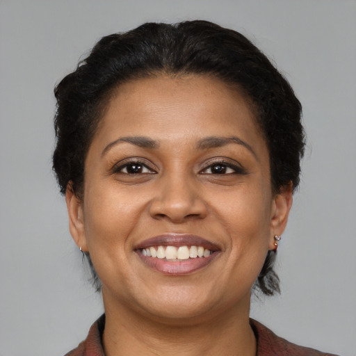 Joyful latino young-adult female with short  brown hair and brown eyes