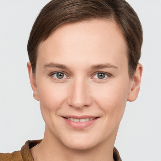 Joyful white young-adult female with short  brown hair and grey eyes