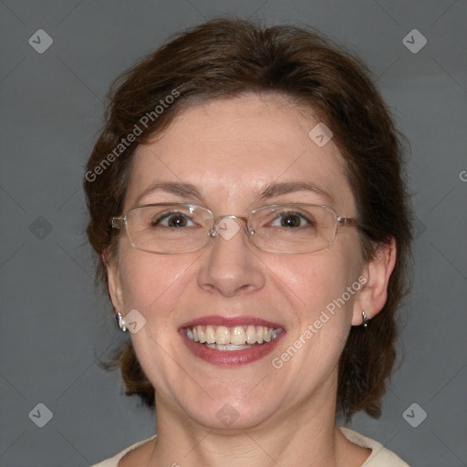 Joyful white adult female with medium  brown hair and blue eyes