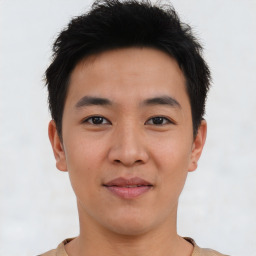 Joyful asian young-adult male with short  brown hair and brown eyes