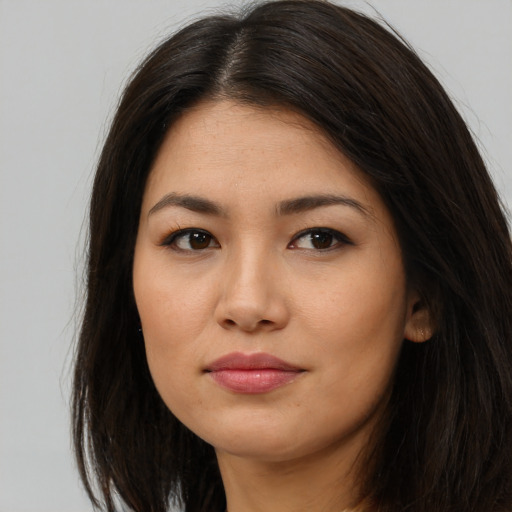 Joyful asian young-adult female with long  brown hair and brown eyes