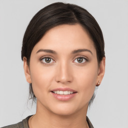 Joyful white young-adult female with medium  brown hair and brown eyes