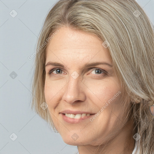 Joyful white adult female with medium  brown hair and grey eyes