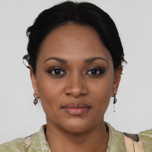 Joyful black young-adult female with short  black hair and brown eyes
