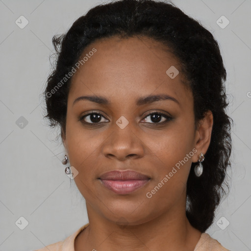 Joyful black young-adult female with long  brown hair and brown eyes