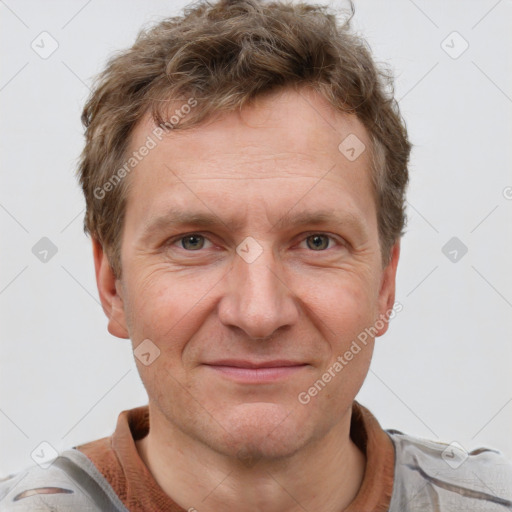 Joyful white adult male with short  brown hair and grey eyes