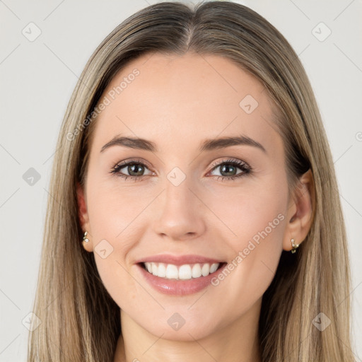 Joyful white young-adult female with long  brown hair and brown eyes