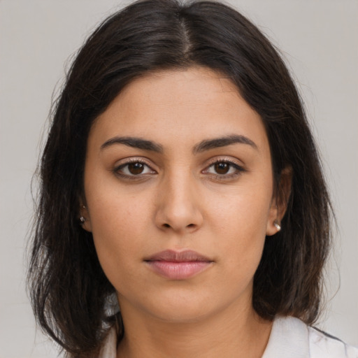 Neutral latino young-adult female with long  brown hair and brown eyes